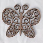 Laser-cut MDF butterfly coaster with scrollwork design