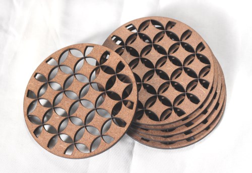 Round coasters with geometric laser-cut patterns Laser-cut geometric MDF coaster set