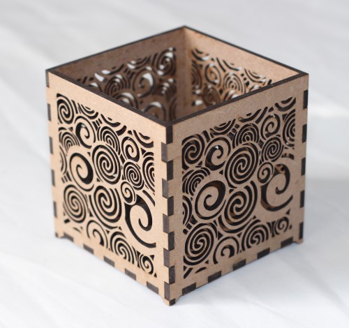 Decorative swirling laser-cut T-light candle holder Small laser-cut MDF T-light holder with swirling pattern